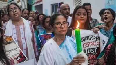 Mamata Banerjee with supporters stages a candle march to protest the alleged rape and murder of a girl at Baruipur (Image/PTI) 'I am being kept under police watch': Mamata Banerjee accuses cops of acting like 'BJP cadres'