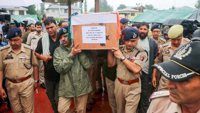 Police officials carry the mortal remains of the Police constable who was killed in a terrorist attack Terrorist kill J&K cop in Anantnag market, first strike since Pahalgam attack