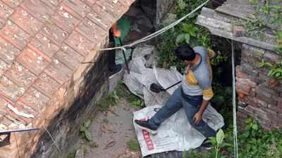An official inspecting the blast site in Kolkata Crude bomb? One detained after blast damages residential building in Kolkata