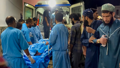 Medical personnel shift an injured migrant worker to an ambulance outside the Government Medical College (GMC) Hospital Chhattisgarh worker shot dead, another wounded in first J&K terror attack on migrants in 21 months